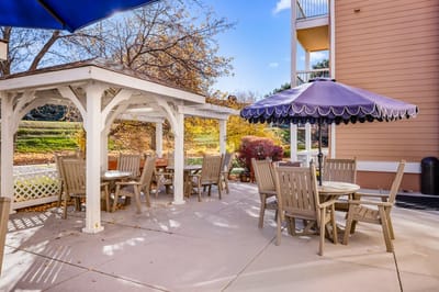 Outdoor seating area with tables and umbrellas