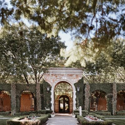 Stone archway entrance surrounded by greenery.
