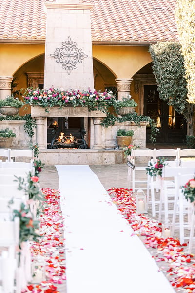 Outdoor ceremony setup with flowers and seating.