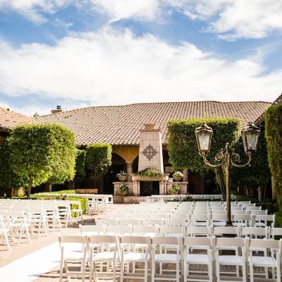 Outdoor ceremony setup with seating and greenery