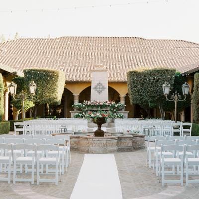 Outdoor ceremony setup with chairs and flowers