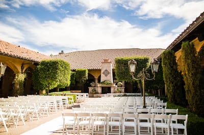 Outdoor ceremony space with seating and greenery