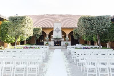Outdoor wedding setup with chairs and decorations.