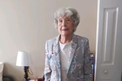 Senior woman standing in a residential room.