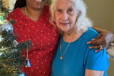Resident and staff member celebrating together.