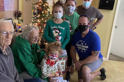 Residents and staff celebrating during the holiday season.