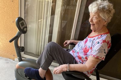 A senior woman enjoying a therapy exercise.