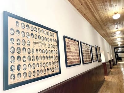 Hallway displaying framed historical photos.