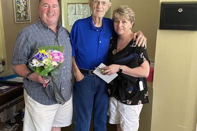 Residents and staff celebrating with flowers
