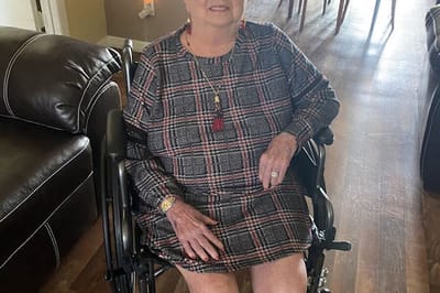 Resident seated in a wheelchair indoors