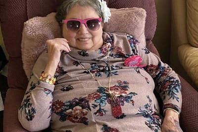 Resident smiling in a chair with sunglasses.