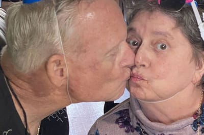 Two residents share a playful kiss.