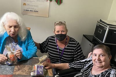 Residents interacting with staff at a table