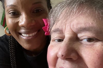 A staff member posing with a resident.