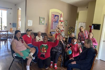 Residents celebrating in a common area with decorations.