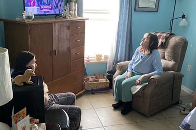 Residents enjoying a TV program in a cozy room.