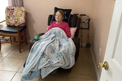 Senior resident relaxing in a chair