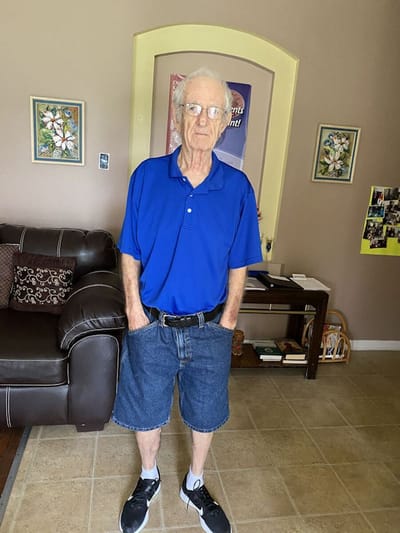 Elderly man standing in a living room