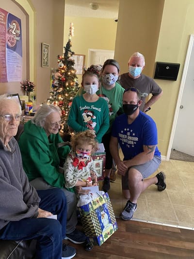 Residents and staff celebrating during a holiday event