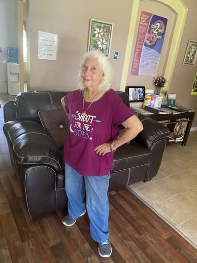 Resident posing in a common area of the facility.