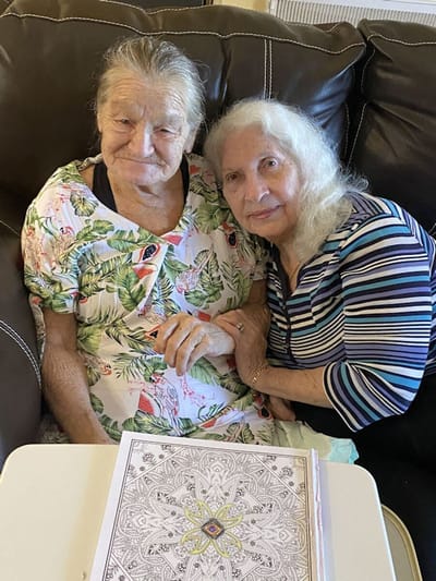 Two women sitting together in a cozy setting.