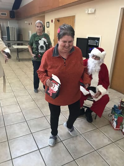 Residents celebrating with Santa at a holiday event.