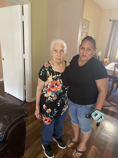 Resident with staff member in shared space.