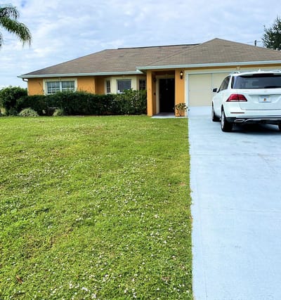 Exterior view of a single-family home with greenery.