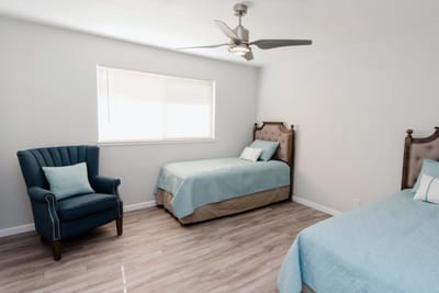 Bright shared bedroom with cozy furnishings.