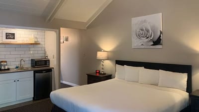 A cozy resident room with a bed and kitchenette.
