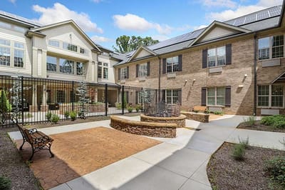 Outdoor seating area with landscaping and fountain.