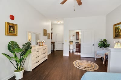 A well-decorated resident room with furniture and art.