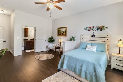Brightly decorated private room with a bed and chair