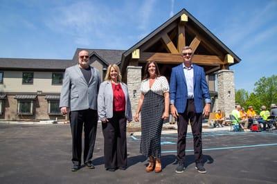 Group of people in front of the facility building