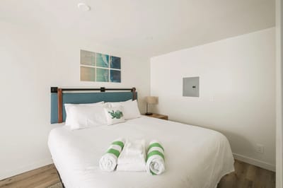 A bright, well-decorated bedroom with a double bed.
