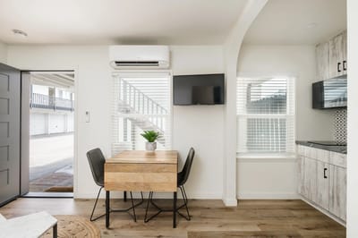 Modern interior space with a dining table and kitchenette