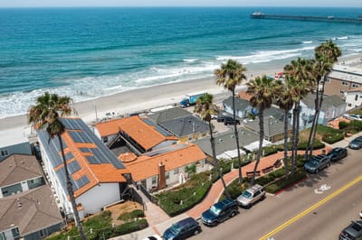Aerial view of beachfront property and palm trees