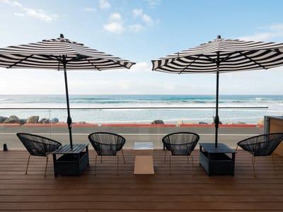 Seating area with umbrellas by the ocean