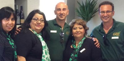 Staff members smiling together in a common area