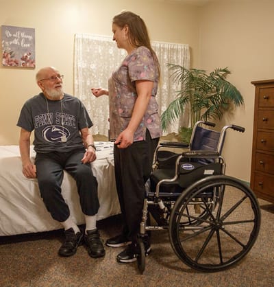 Staff member assisting resident in a room