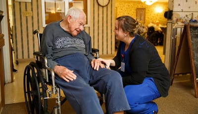 Staff member engaging with a resident in a common area