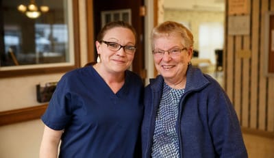 Staff member and resident smiling together