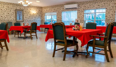 Dining area with red tables and green chairs