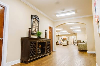 Interior hallway with decorative furnishings and seating.