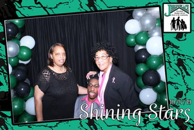 Three individuals celebrating at an event