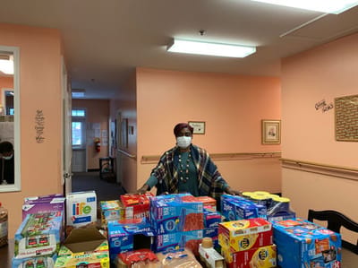 Staff member with a table of food items in the interior