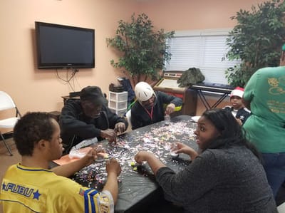 Residents and staff engaged in a craft activity.