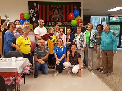 Residents and staff celebrating in a common area.