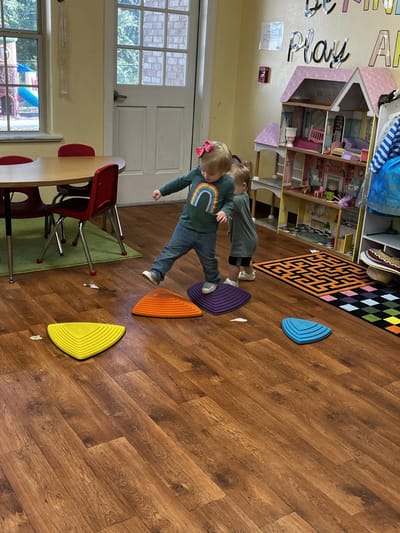Children engaging in play activity indoors.