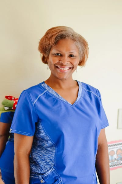 Smiling staff member in a care facility.